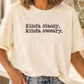 Person wearing a white t-shirt with text 'kinda classy, kinda sweary.'