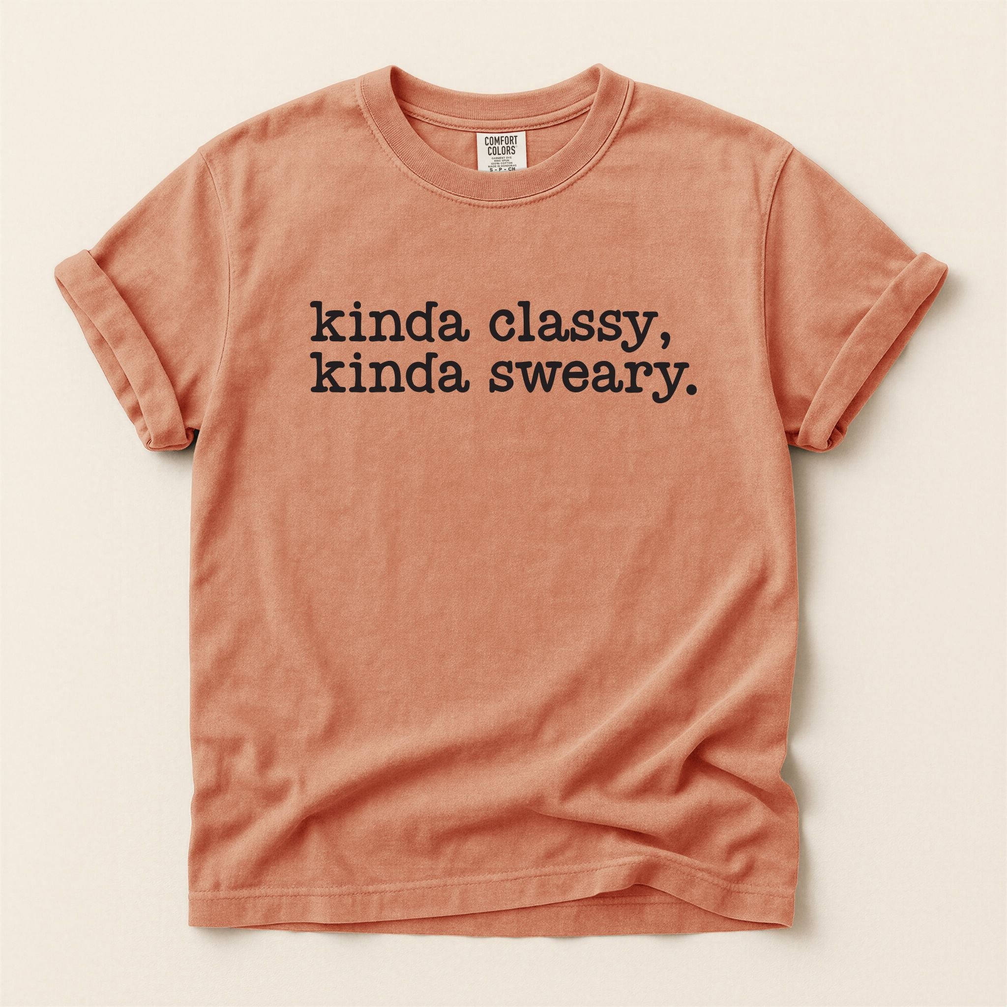 Terracotta t-shirt with text 'kinda classy, kinda sweary.' on a beige background