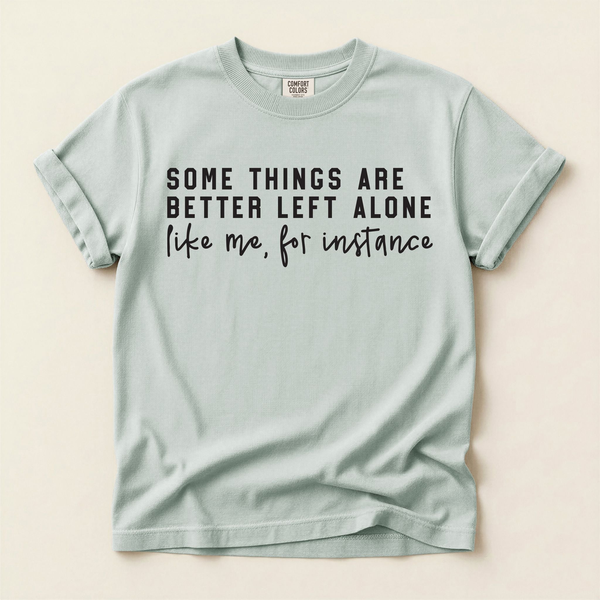 Light blue t-shirt with humorous text on a beige background