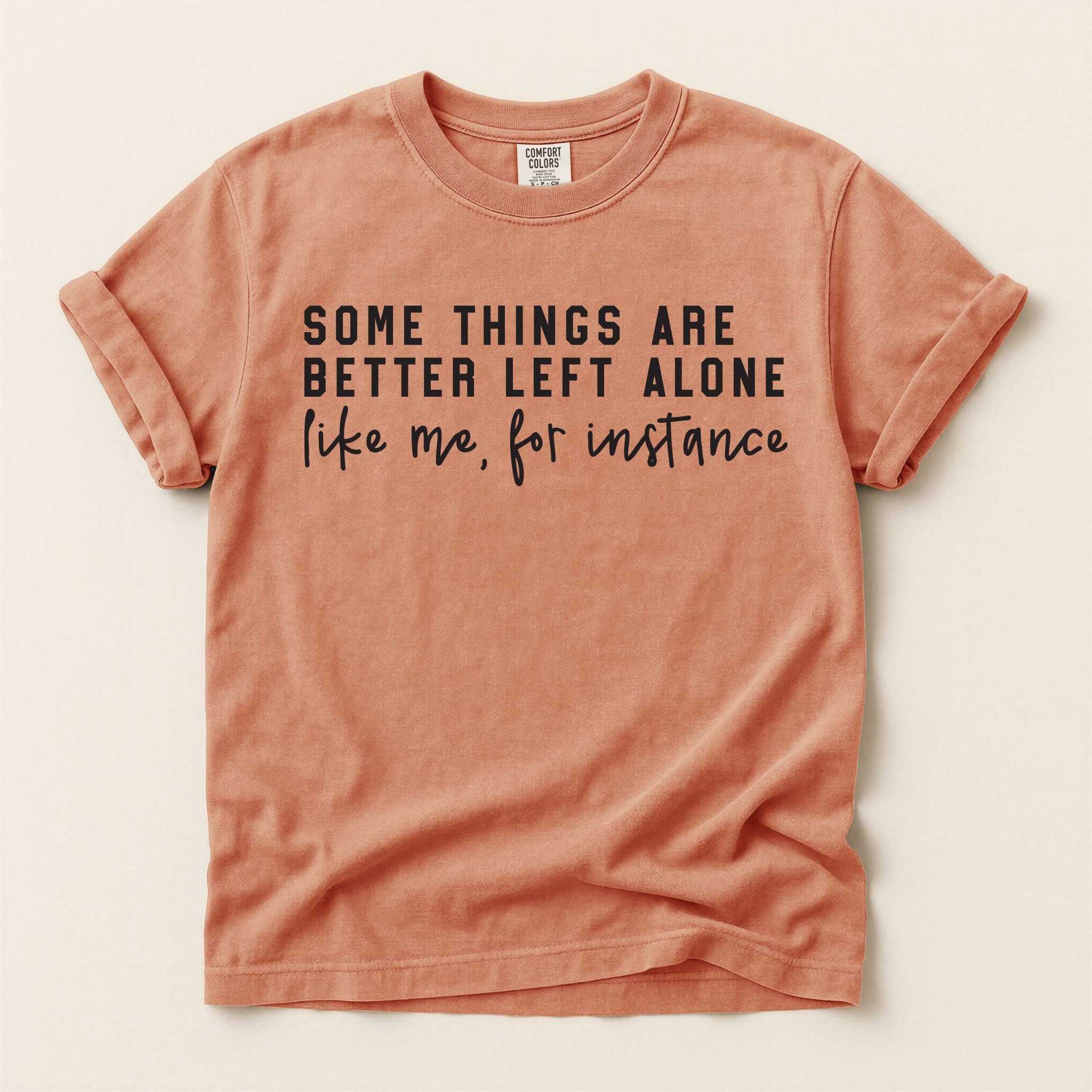 Terracotta t-shirt with black text on a beige background