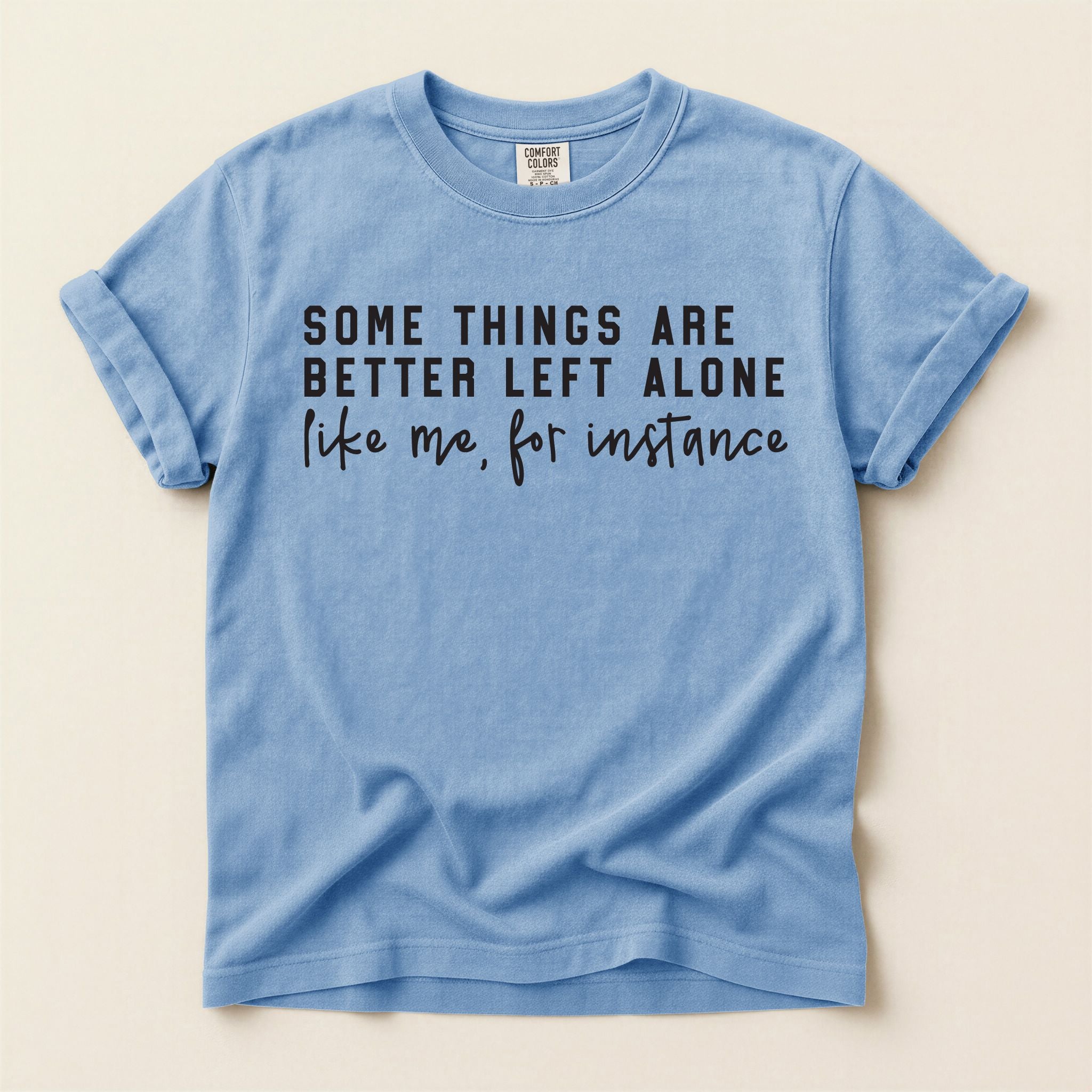 Blue t-shirt with black text on a beige background