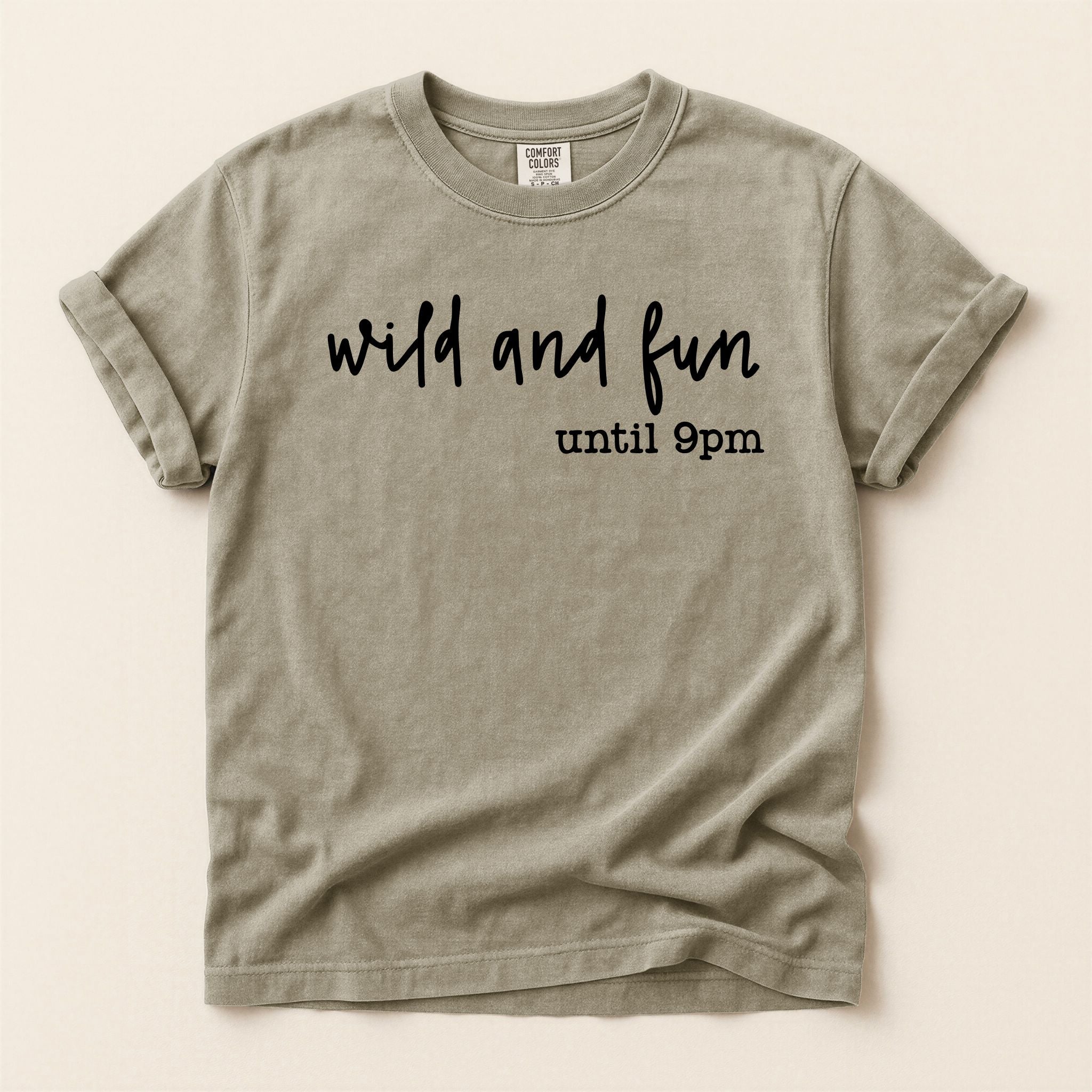 Beige t-shirt with 'wild and fun until 9pm' text on a beige background