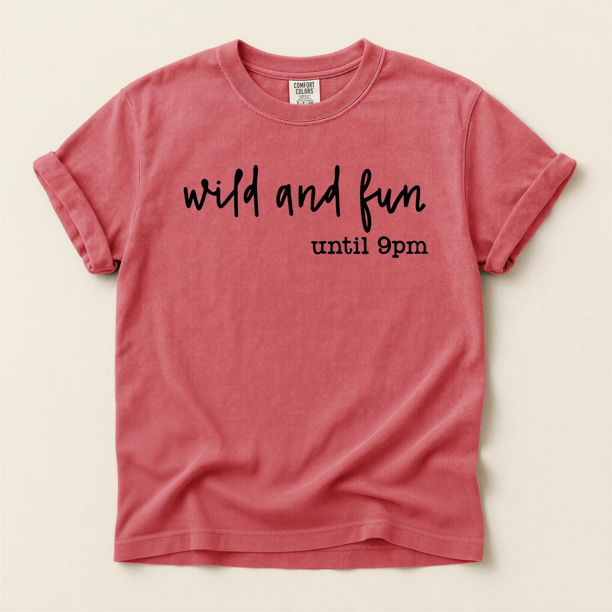 Red t-shirt with 'wild and fun until 9pm' text on a beige background