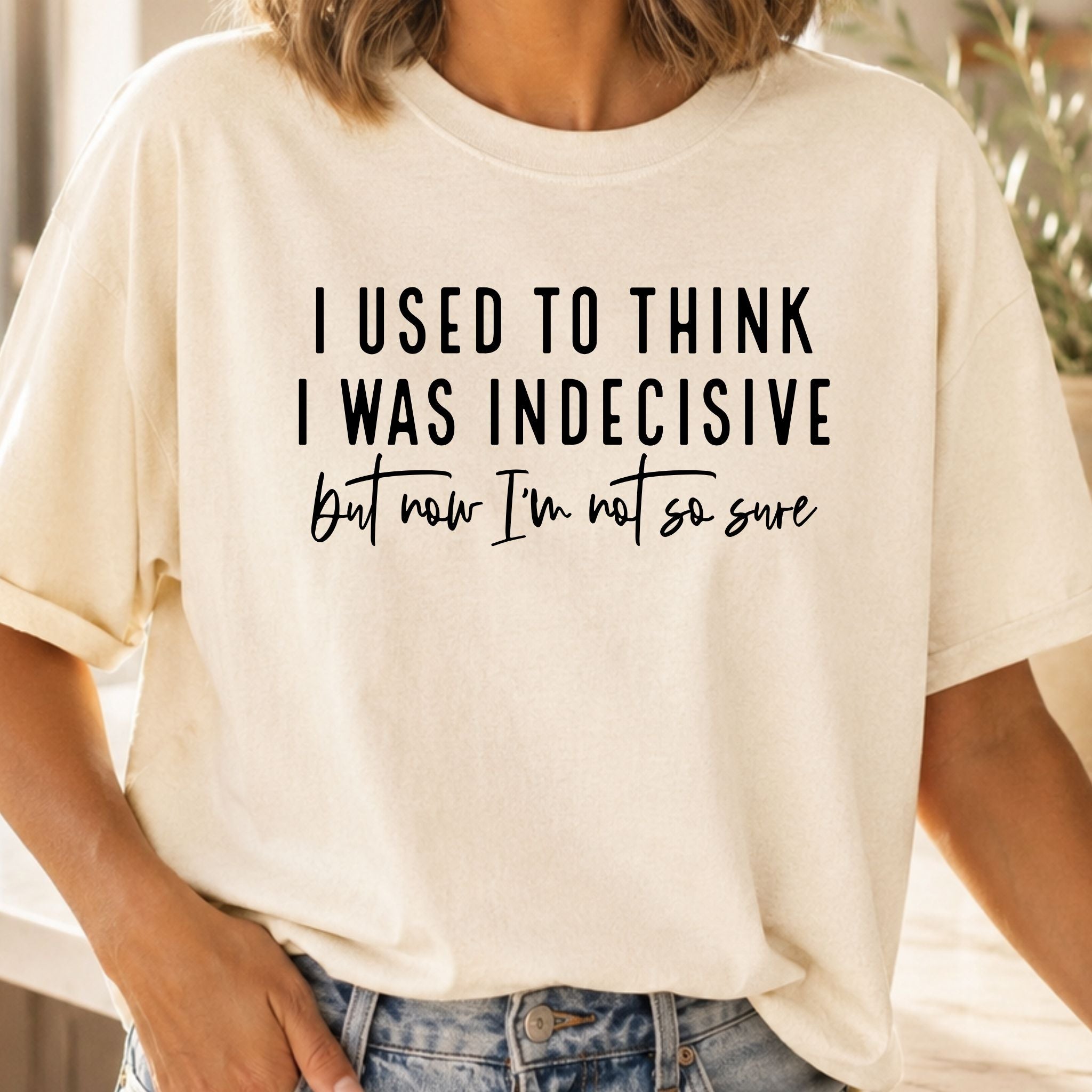Person wearing a white t-shirt with humorous text design.